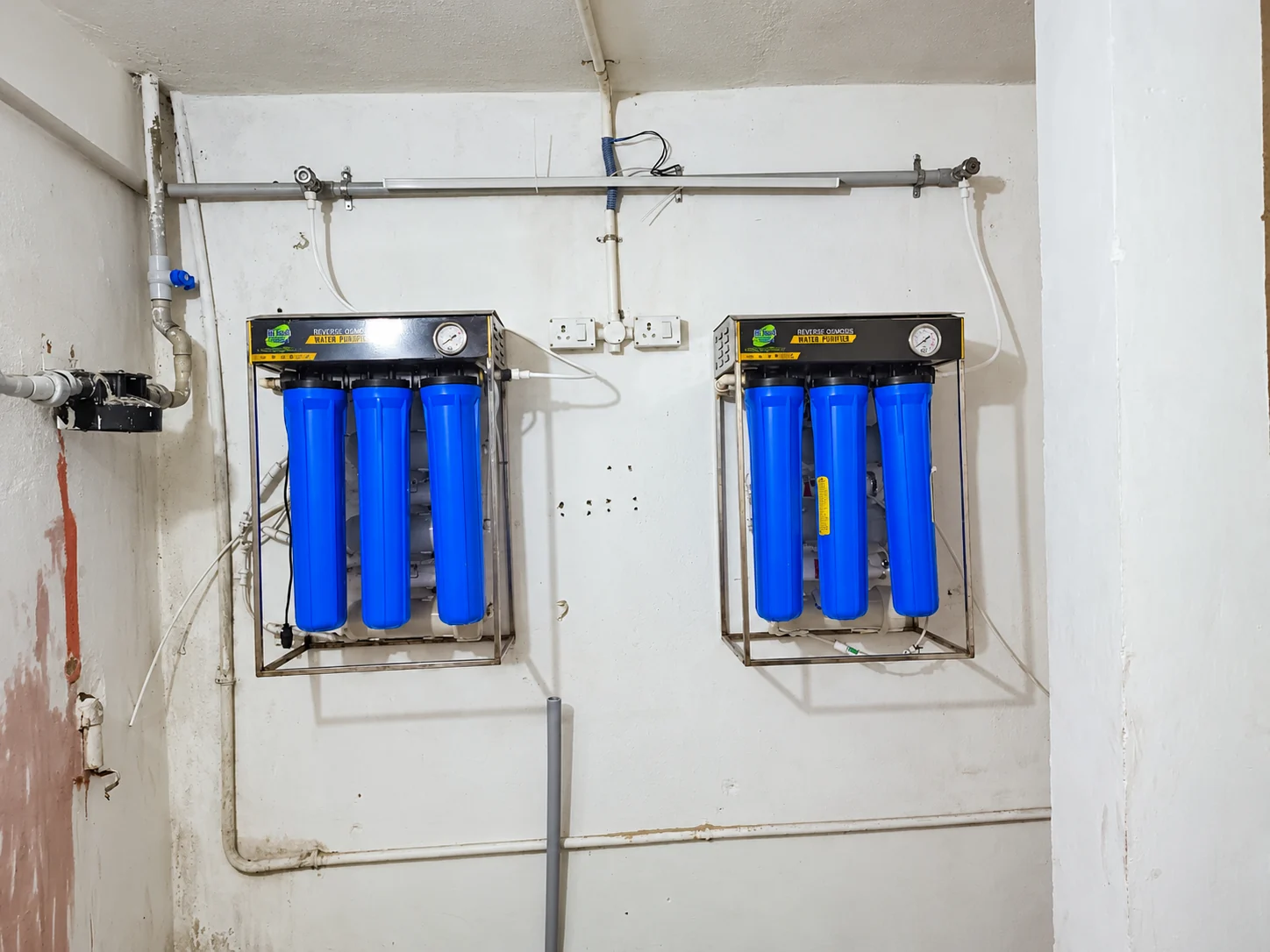 Two wall-mounted reverse osmosis water purification units