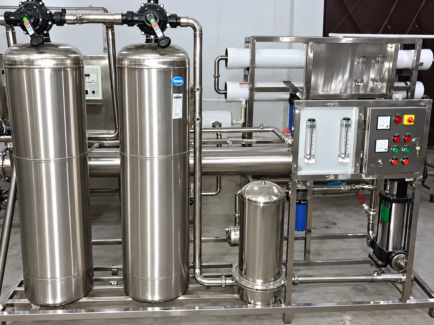 Stainless steel water treatment system with twin filter vessels, membrane housings and control panel